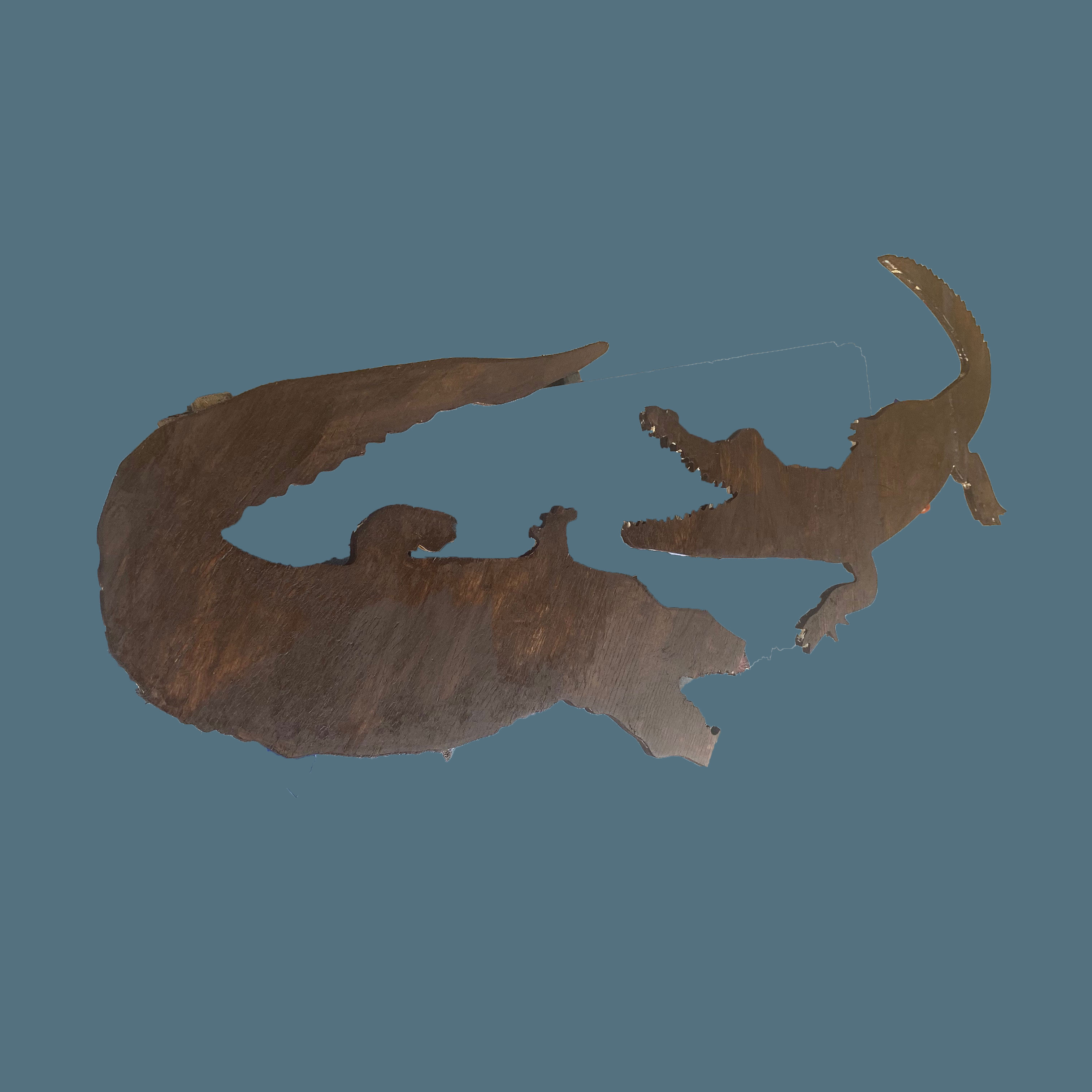 Carved wooden alligator and crocodile silhouette